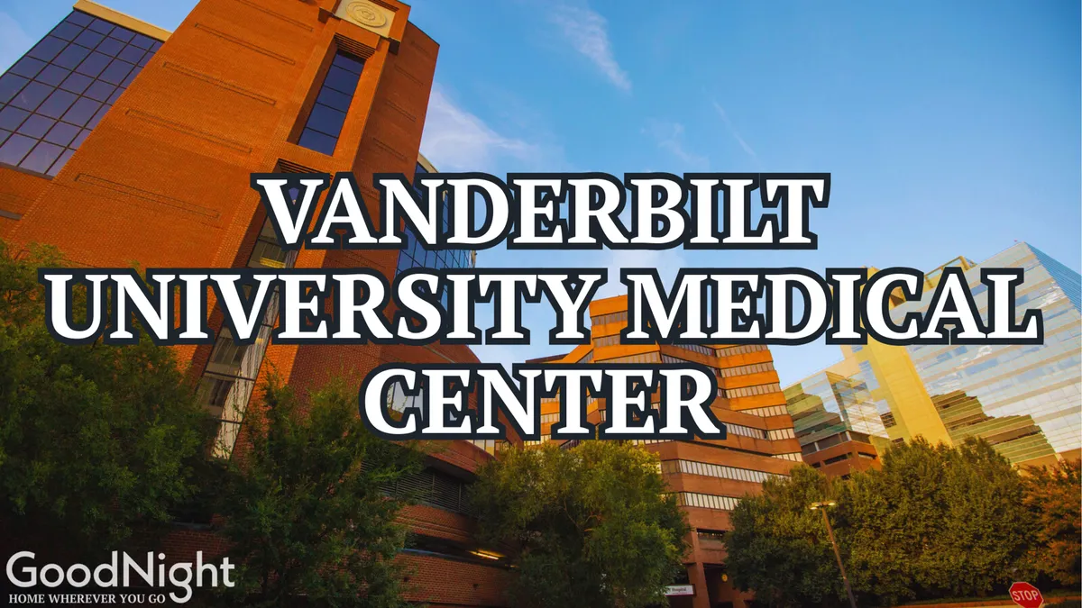 This image showcases the Vanderbilt University Medical Center building surrounded by trees, with the city skyline in the background. The hospital's modern architecture is prominent, set in a lush, accessible environment.